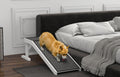 Dog using a pet ramp to get onto a bed in a bedroom setting